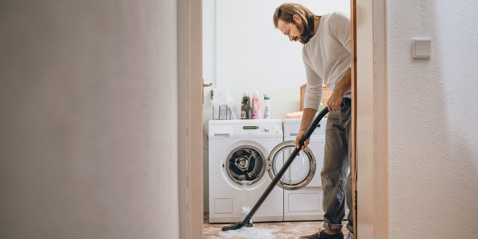 Person vacuums dry floor Kärcher wet and dry vacuum cleaners